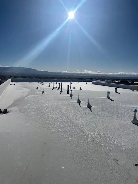 Individuals walk on a sunlit frozen lake, enjoying the crisp winter air and the beauty of the shimmering ice.